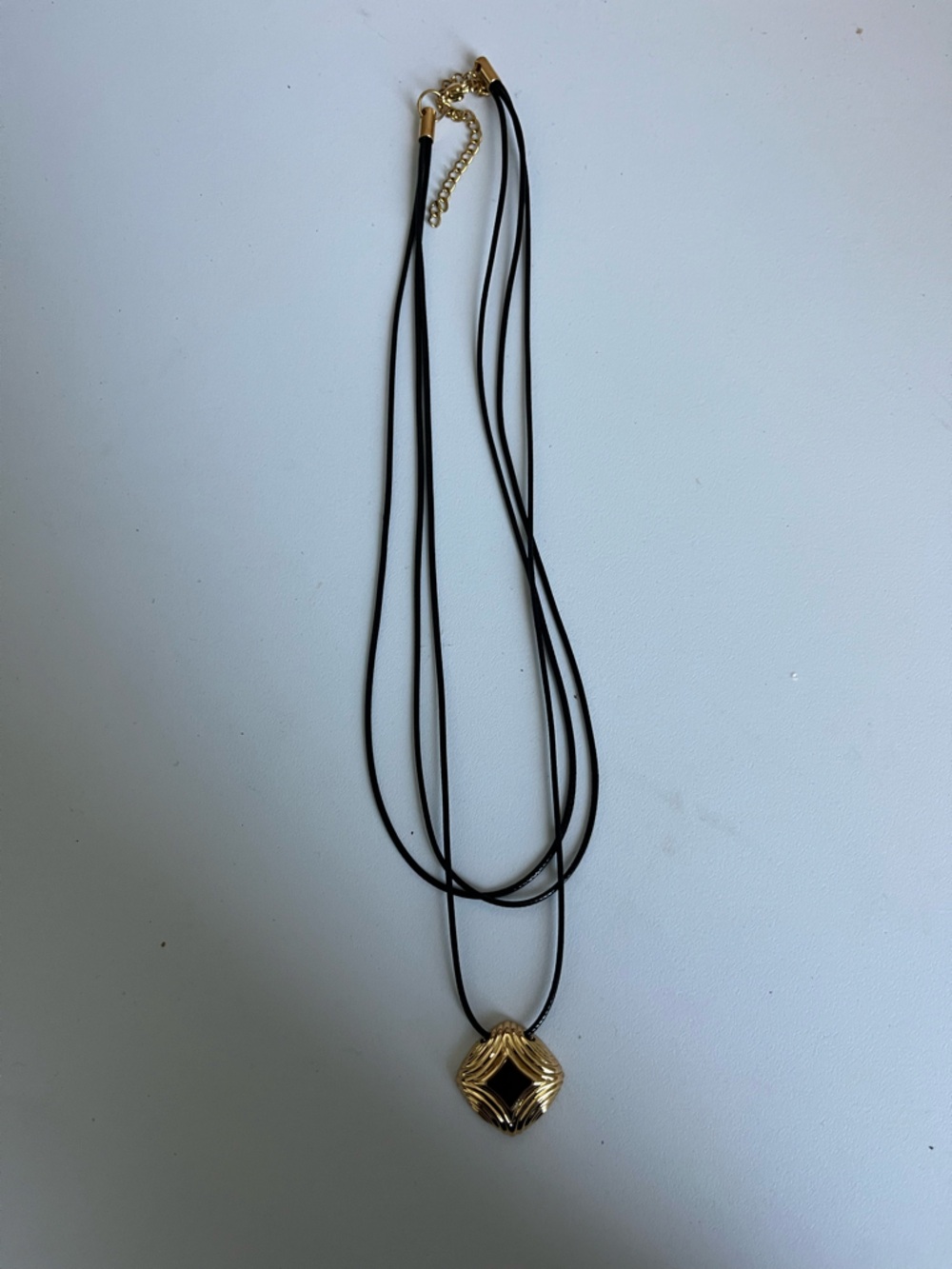 Multi-Strand Black Cord Necklace with Gold Geometric Pendant